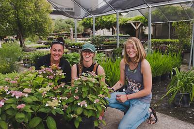 students behind plants in nursery